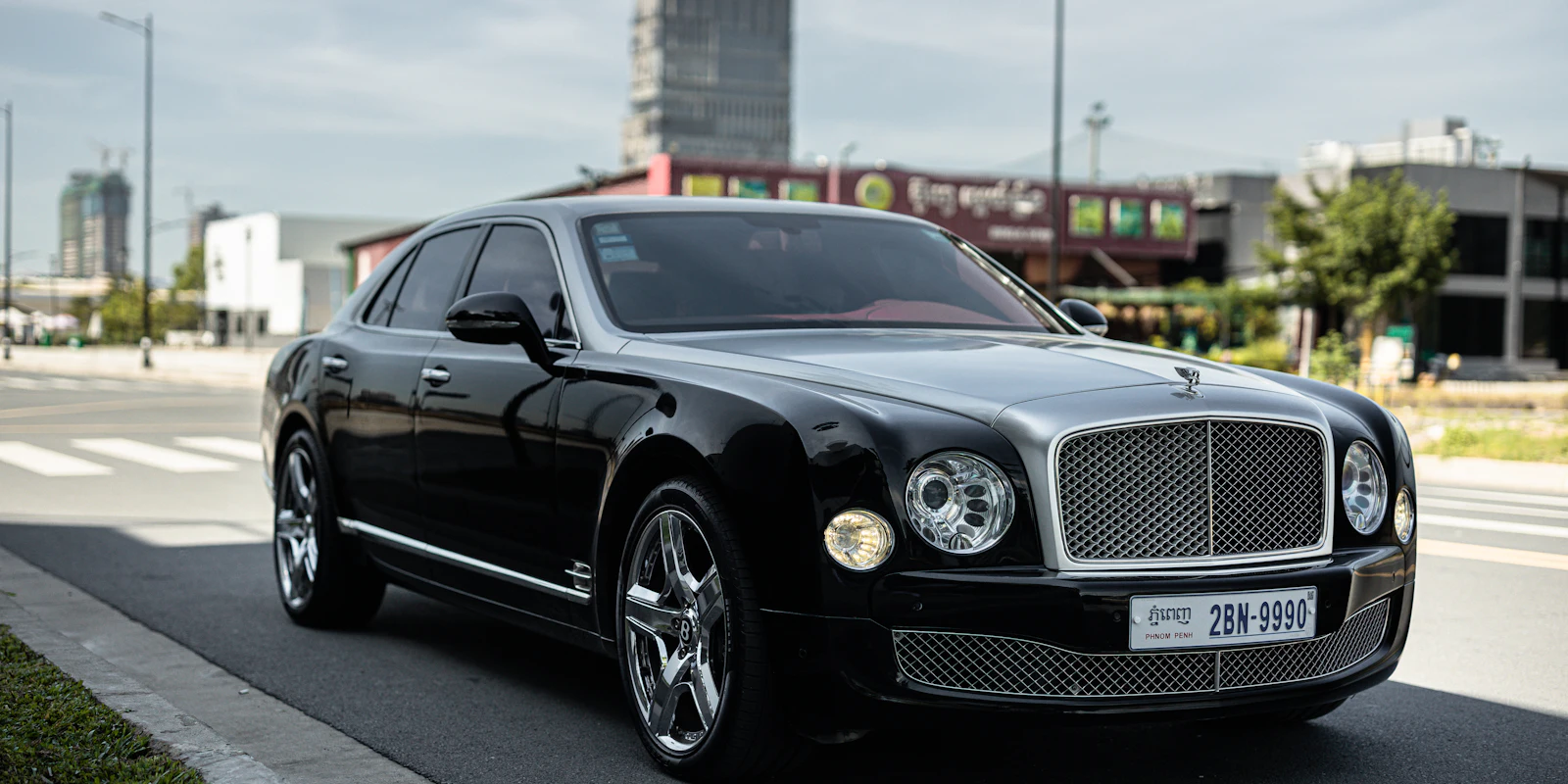 Black Bentley sedan on the road