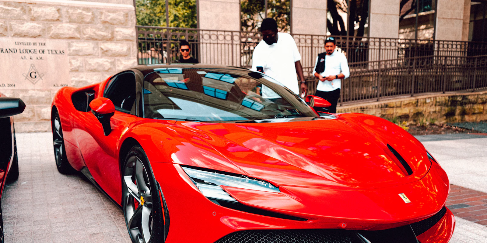 Red Ferrari SF90 Spider parked outside