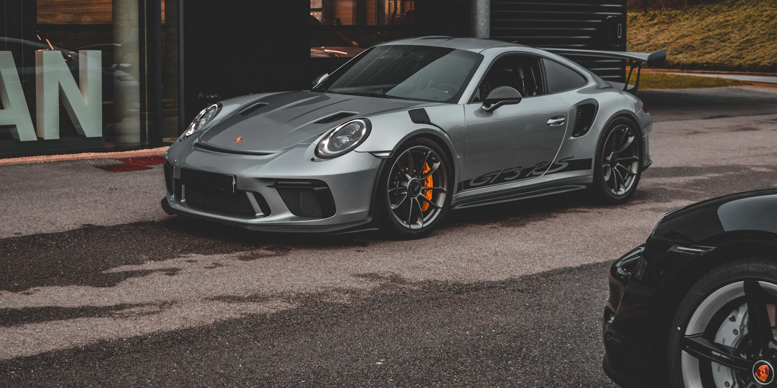 Grey Porsche 911 GT3 RS parked in front of a building